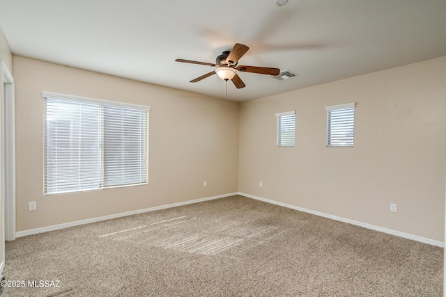 empty room with carpet flooring and ceiling fan