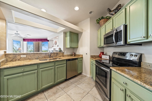 kitchen featuring sink, green cabinetry, ceiling fan, light tile patterned floors, and stainless steel appliances