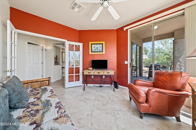 living room featuring french doors and ceiling fan