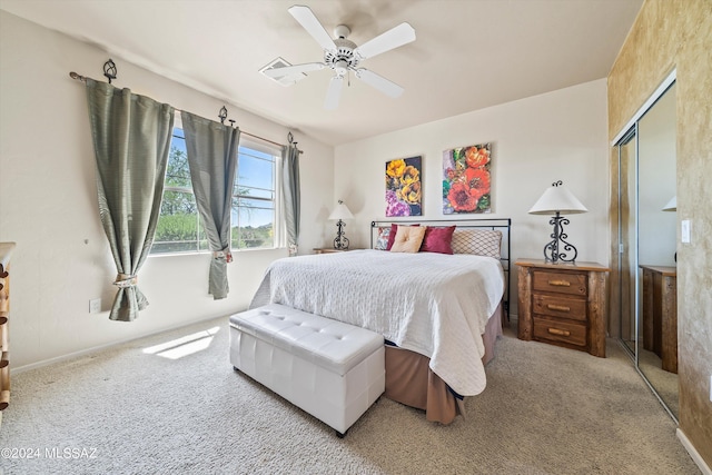 carpeted bedroom with a closet and ceiling fan