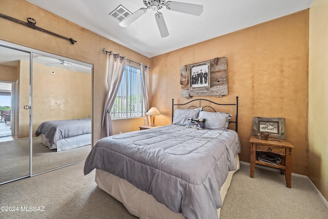 carpeted bedroom with a closet and ceiling fan