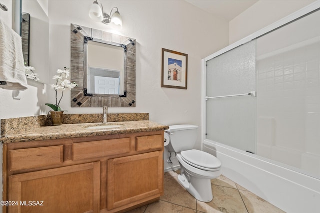 full bathroom with shower / bath combination with glass door, tile patterned flooring, vanity, and toilet