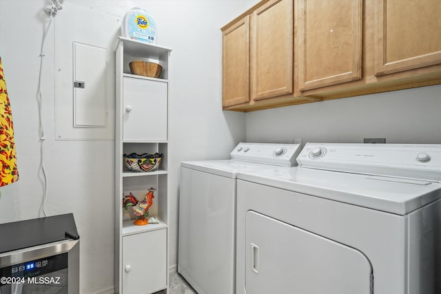 laundry area with cabinets, electric panel, and washing machine and clothes dryer