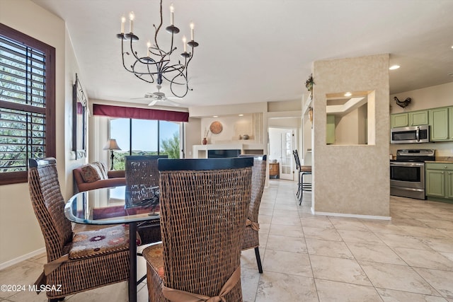 dining space with light tile patterned floors and ceiling fan with notable chandelier