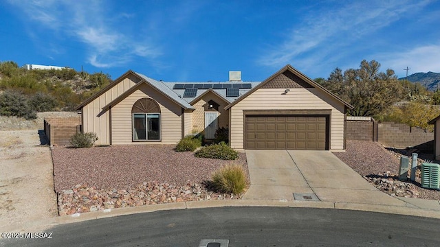 view of front of home featuring solar panels and a garage