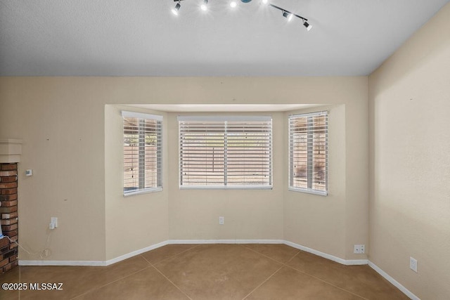 tiled empty room with track lighting