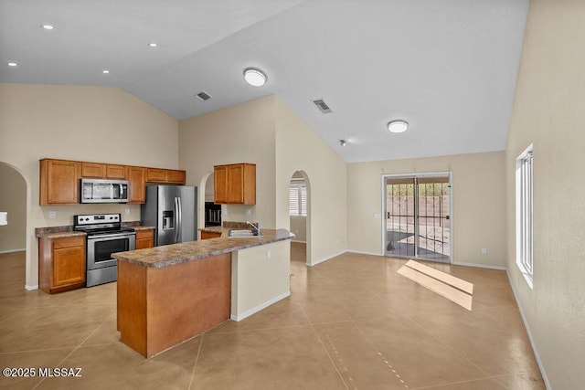 kitchen featuring appliances with stainless steel finishes, sink, high vaulted ceiling, and light tile patterned flooring