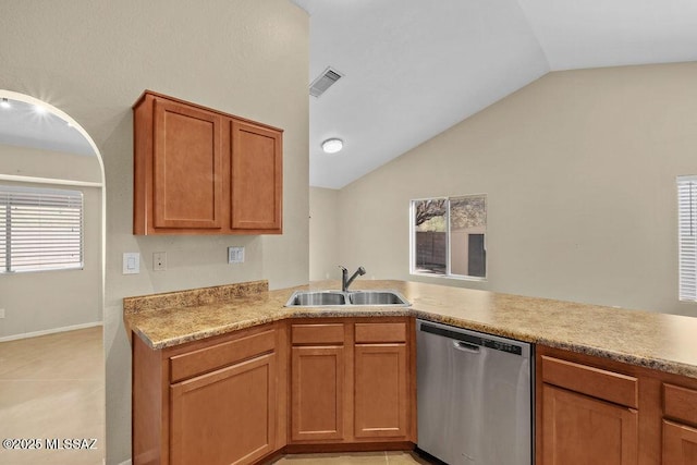 kitchen with light tile patterned floors, vaulted ceiling, stainless steel dishwasher, and sink