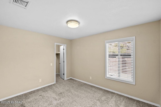 unfurnished room with light colored carpet