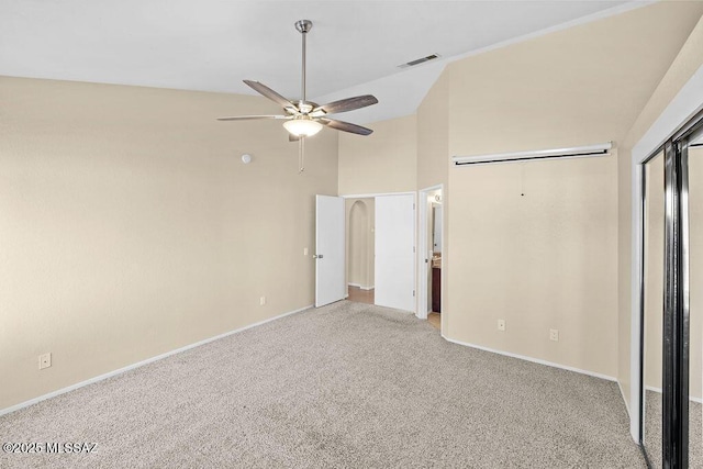 unfurnished bedroom with a closet, light colored carpet, vaulted ceiling, and ceiling fan