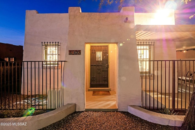 view of exterior entry at dusk