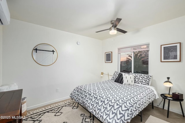 bedroom with an AC wall unit and ceiling fan