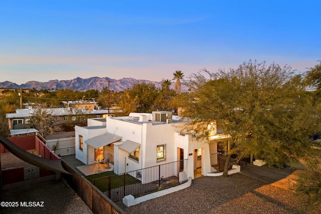 view of front of house with a mountain view and central air condition unit