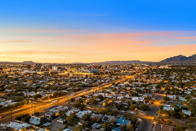 aerial view at dusk featuring a mountain view