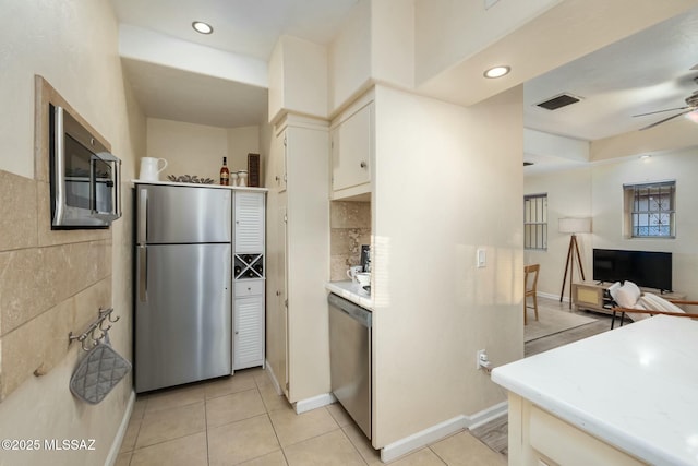 kitchen featuring stainless steel appliances, light tile patterned flooring, and ceiling fan