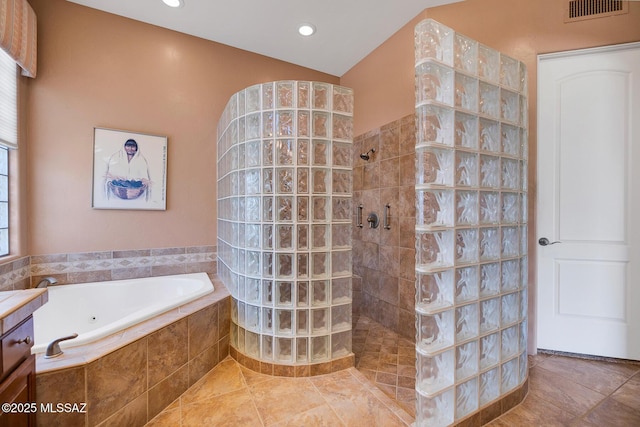 bathroom featuring independent shower and bath, vanity, and tile patterned flooring