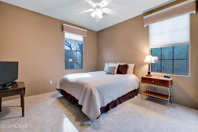 bedroom with ceiling fan and carpet flooring