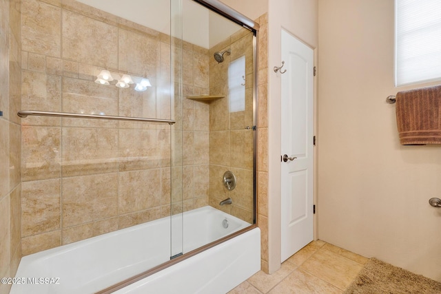 bathroom featuring tile patterned flooring and shower / bath combination with glass door