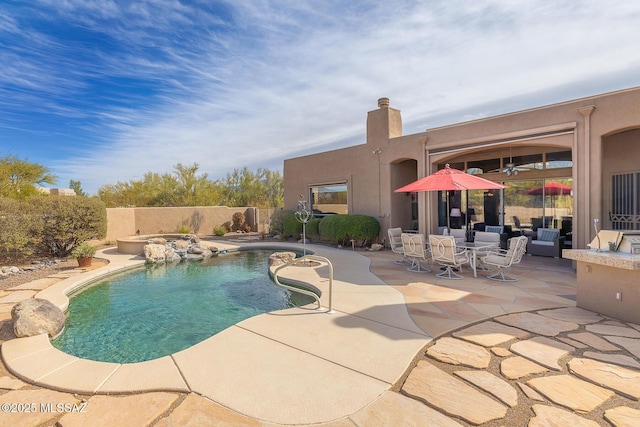 view of swimming pool with a patio area