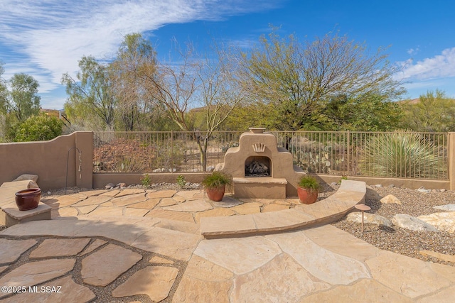 view of patio featuring exterior fireplace