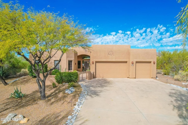 pueblo-style house with a garage