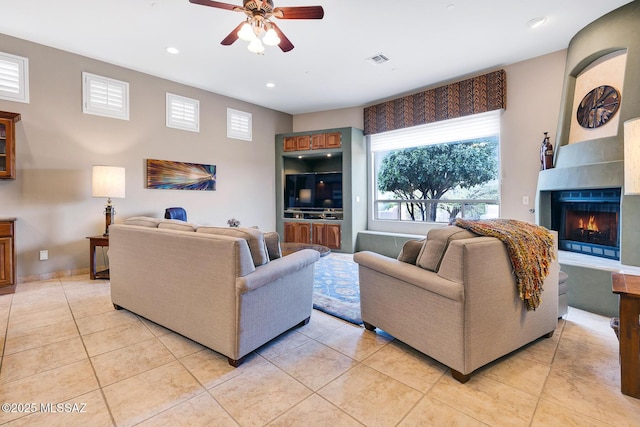 living room featuring ceiling fan and light tile patterned floors