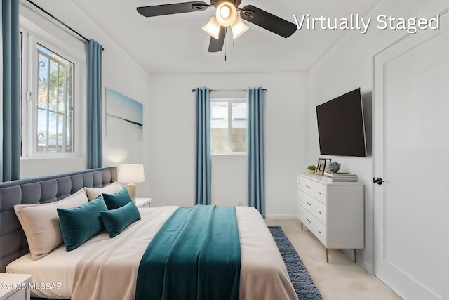 bedroom with a ceiling fan, baseboards, and light carpet