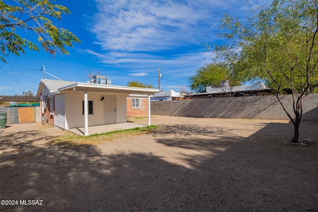 back of house with a patio and a fenced backyard