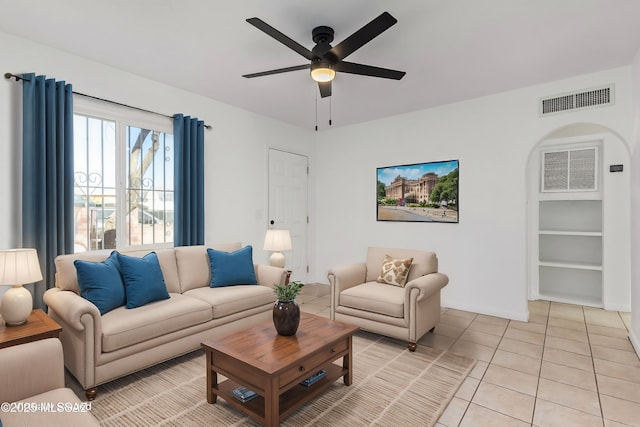 tiled living room with ceiling fan