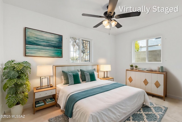 bedroom featuring multiple windows, a ceiling fan, and baseboards