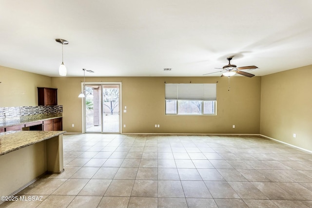 unfurnished living room with light tile patterned floors and ceiling fan