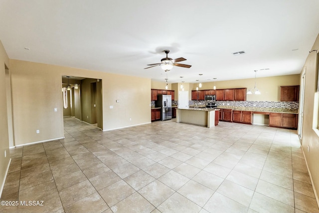 kitchen with tasteful backsplash, decorative light fixtures, a center island, appliances with stainless steel finishes, and ceiling fan