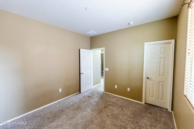 unfurnished bedroom with light colored carpet