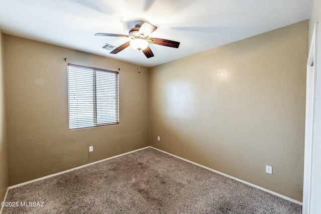 carpeted spare room featuring ceiling fan