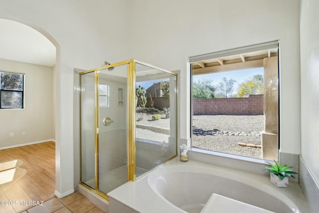 bathroom with a bath and tile patterned flooring