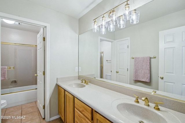 full bathroom with vanity, tile patterned floors, toilet, and combined bath / shower with glass door