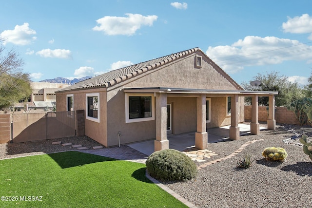 11215 N Via Rancho Naranjo, Oro Valley, AZ 85737 - rear view of house featuring a gate, fence, a patio, stucco siding, and a lawn