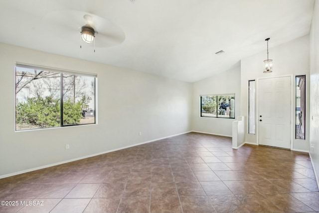 entryway with ceiling fan, lofted ceiling, and tile patterned flooring