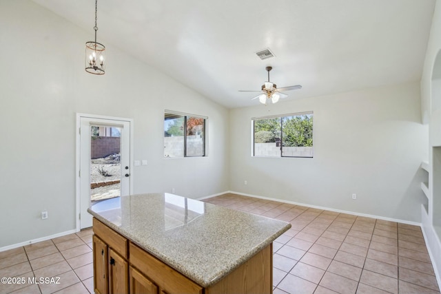11215 N Via Rancho Naranjo, Oro Valley, AZ 85737 - kitchen with vaulted ceiling, light tile patterned flooring, hanging light fixtures, and ceiling fan with notable chandelier