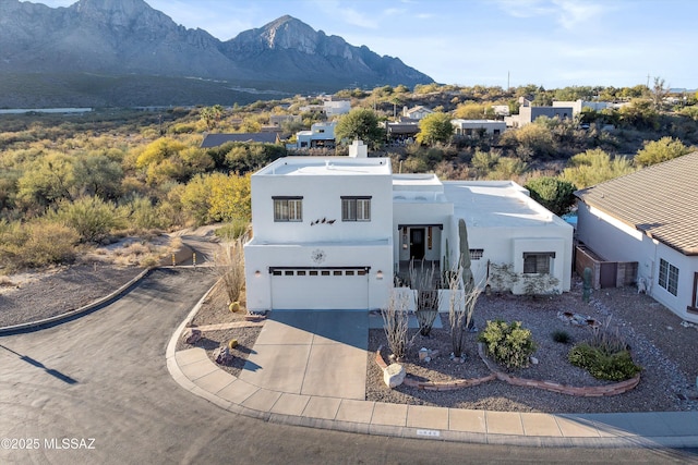 view of front of home with a mountain view and a garage