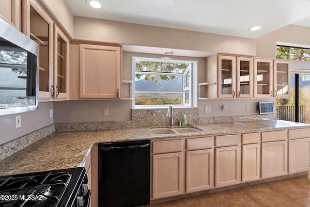 kitchen with light stone countertops, sink, black appliances, and light brown cabinets