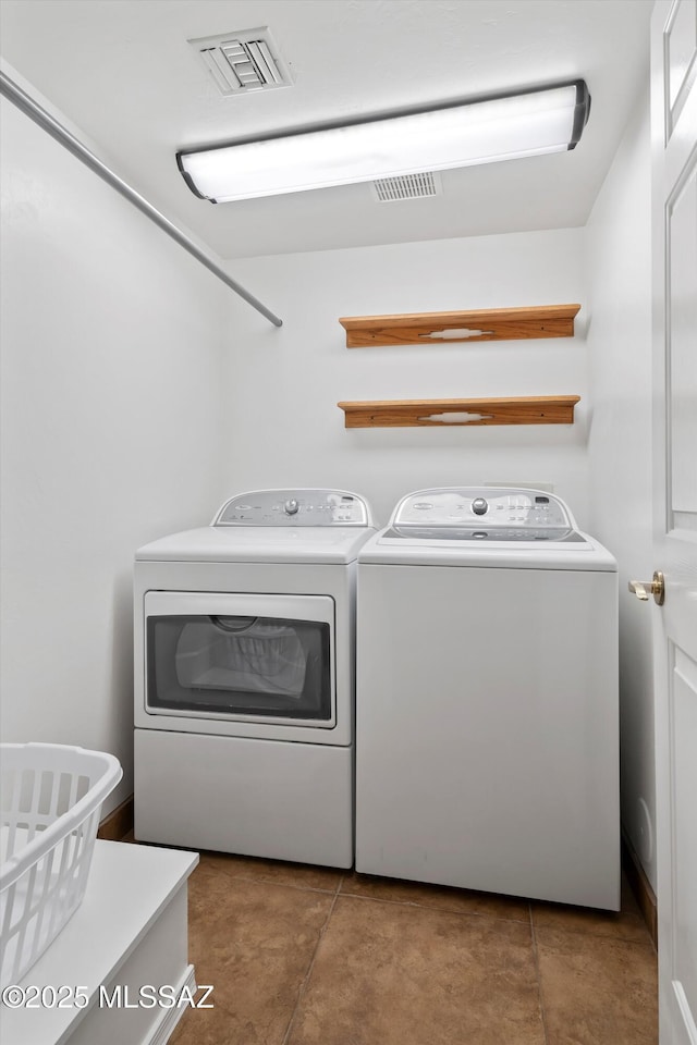 washroom featuring washing machine and clothes dryer and tile patterned floors