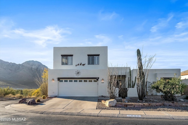 view of front of house featuring a mountain view and a garage