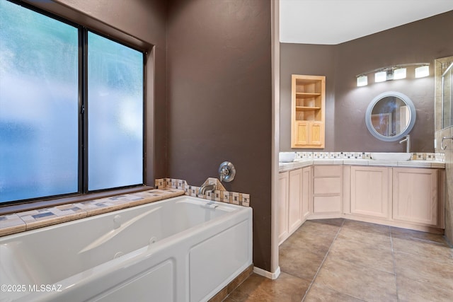 bathroom featuring built in shelves, vanity, tile patterned floors, and a bathing tub