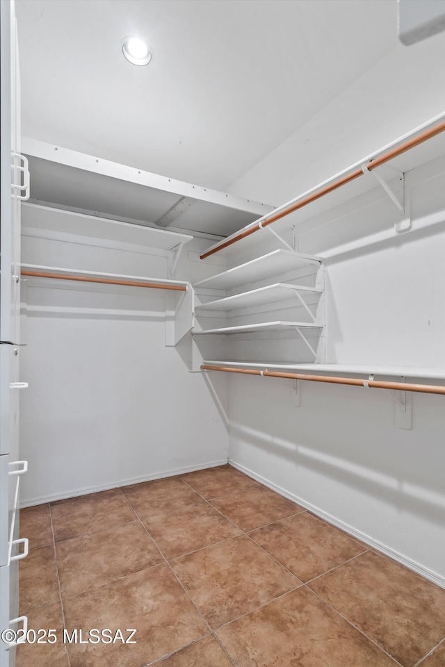 spacious closet featuring tile patterned floors