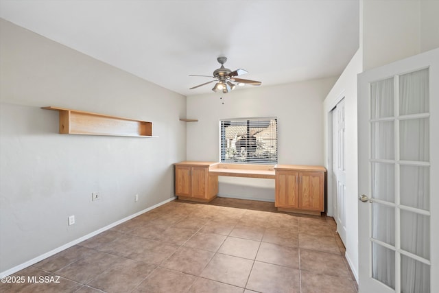 unfurnished office with ceiling fan and light tile patterned floors