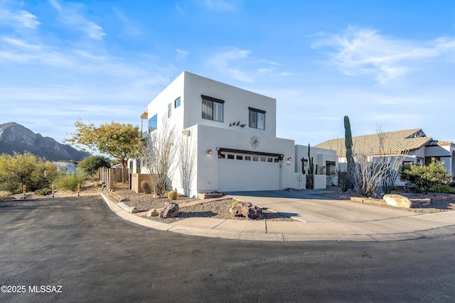 contemporary house featuring a mountain view, a garage, and central AC