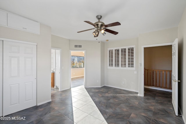 unfurnished room with ceiling fan