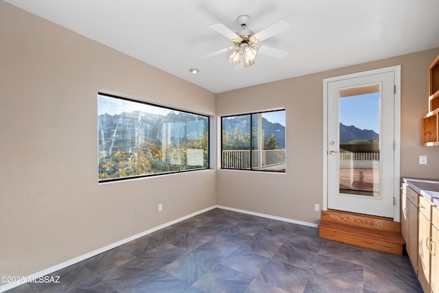 interior space featuring ceiling fan, a mountain view, and lofted ceiling