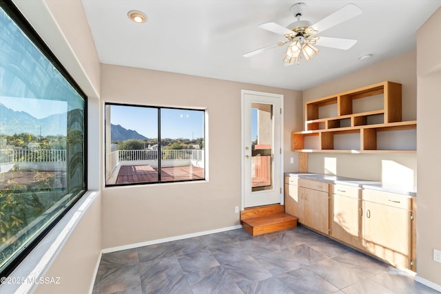 interior space with a mountain view, plenty of natural light, and ceiling fan